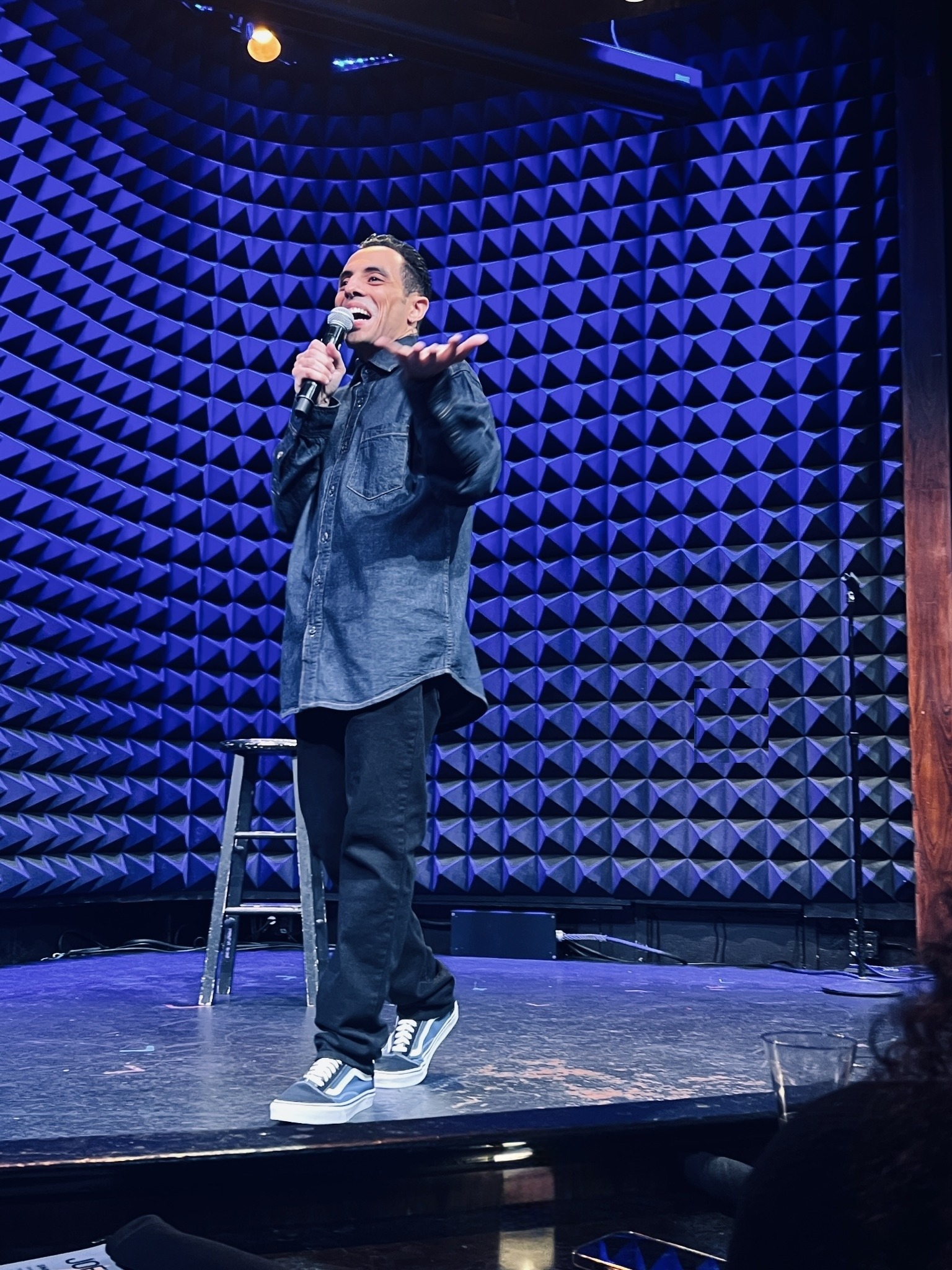 Eman Morgan performing stand-up comedy on stage