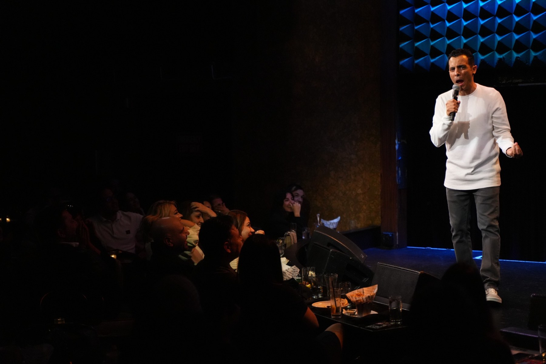 Eman Morgan performing to a comedy club audience